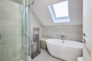 a bathroom with a bath tub and a window at Host & Stay - Carterhouse in Jedburgh