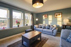 a living room with a couch and a coffee table at Host & Stay - Carterhouse in Jedburgh