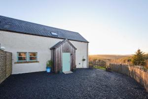 a white building with a door on the side of it at Host & Stay - Carterhouse in Jedburgh
