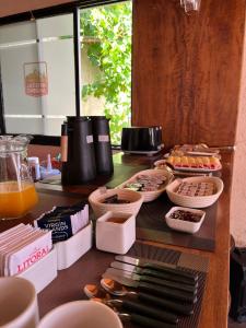 a table topped with plates and bowls of food at Hostal Andino in Eugenio Bustos