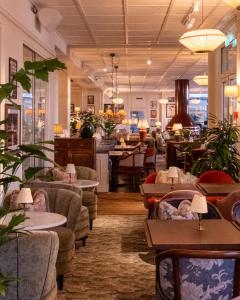 ein Restaurant mit Sofas, Tischen und Stühlen in der Unterkunft Ystad Saltsjöbad in Ystad