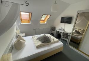 a bedroom with a bed and a desk and a mirror at Akzent Berghotel Rosstrappe in Thale +40 photos