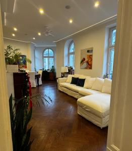 a living room with two white couches and windows at Luxury apartment in center town! in Poznań
