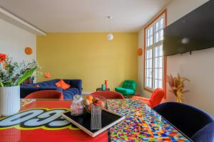 a room with a table with a colorful table cloth at Duplex coloré 6 personnes Place des Héros - vue Beffroi - Centre ville in Arras