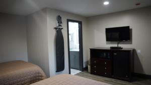 ein Schlafzimmer mit einem Bett und einer an der Wand hängenden Krawatte in der Unterkunft Best Way Inn in Middlefield