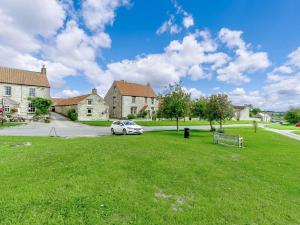 a car parked in a grassy yard in front of a house at 2 Bed in Newton-on-Rawcliffe 88955 in Newton