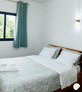 a bedroom with a bed with a blue curtain at Maison moderne et spacieuse 9 min Ivato aeroport 