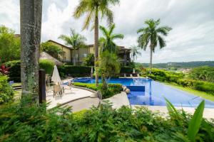 a resort with a swimming pool and palm trees at Vista Bahia 1G - 3bed 3 bath Ocean View in La Mona