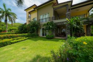 a house with a lawn in front of it at Vista Bahia 1G - 3bed 3 bath Ocean View in La Mona +65 photos