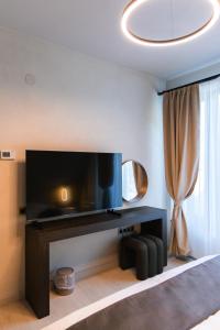 a living room with a large flat screen tv at Twin Vista A-Frame Cabins in Sovata +13 photos