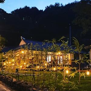 a house with lights in the yard at night at Damyang Hwayang in Damyang