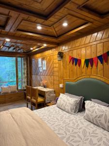 a bedroom with a bed and a table in it at Arcelia Cottage, Cozy Villa in Nainital in Nainital