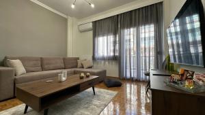 a living room with a couch and a coffee table at Casa Aphrodite Thessaloniki in Thessaloniki
