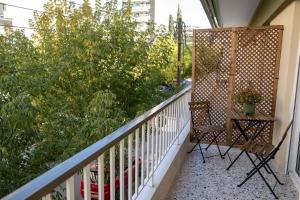 a balcony with a chair and some bushes and trees at Casa Aphrodite Thessaloniki in Thessaloniki