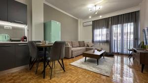 a living room with a couch and a table at Casa Aphrodite Thessaloniki in Thessaloniki