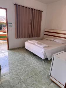 Ένα ή περισσότερα κρεβάτια σε δωμάτιο στο Hotel Pousada Comfort ANTIGA POUSADA TIA ILDA