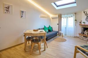 a living room with a table and a blue couch at Casa Vacanze Nonna Bambina in Palena