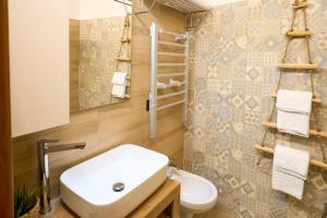 a bathroom with a sink and a toilet at Casa Vacanze Nonna Bambina in Palena