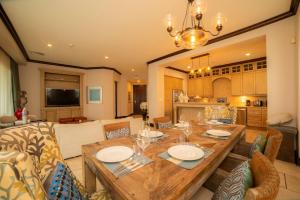 a dining room and living room with a wooden table at Vista Bahia 3C - 3bdr 3 bath ocean View in La Mona