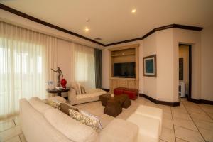 a living room with a couch and a tv at Vista Bahia 3C - 3bdr 3 bath ocean View in La Mona