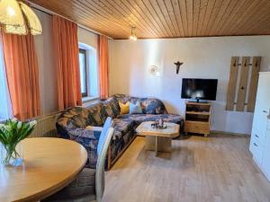 a living room with a couch and a table at Ferienwohnungen am Arber - Haus Osser - in Lohberg