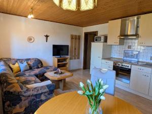 a living room with a couch and a table at Ferienwohnungen am Arber - Haus Osser - in Lohberg