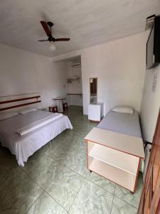 En eller flere senge i et værelse på Hotel Pousada Comfort ANTIGA POUSADA TIA ILDA