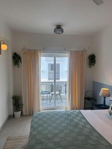 a bedroom with a bed and a sliding glass door at Pansoi - A luxurious cozy stay in Siolim in Oxel