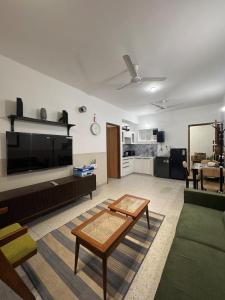 a living room with a couch and a tv and a table at Pansoi - A luxurious cozy stay in Siolim in Oxel +23 photos