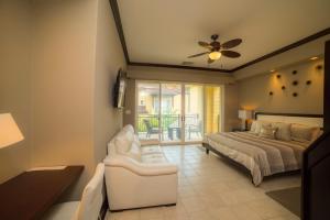 a bedroom with a bed and a couch and a chair at Vista Bahia 3D - 3bdr 3bath plunge pool in La Mona