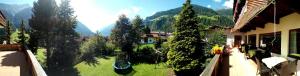 a view of a yard with trees and a house at Hotel Rogen in Neustift im Stubaital