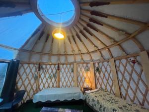 a room with a round ceiling with a bed and a light at Unique Mongolian Yurt near lake together with guest house in Hjo