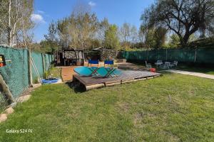 Cabaña la morocha في سيوداد لوجان دي كويو: فناء خلفي مع سطح خشبي وكراسي عليه