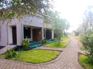 a house with a brick path next to a building at Royal South Luangwa Safaris Lodge in Mfuwe +35 photos