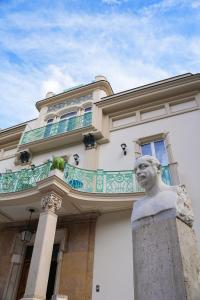 a building with a statue in front of it at Villa Magnolia in Castellammare di Stabia