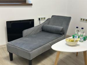 a grey couch with a table and soda bottles at Luxury Resort Hostess in Dej