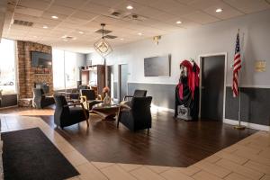 a lobby with chairs and a table and a flag at Chattanooga Heritage Inn in Chattanooga