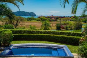 a swimming pool in the middle of a garden at Vista Bahia 3F 1 bedr 1 1 and a half bath ocean view in La Mona +42 photos
