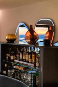 a bar with alcohol bottles on a shelf at Villa Tauris in Emmetten