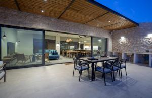 a kitchen and dining room with a table and chairs at Amber by the sea in Évyiros