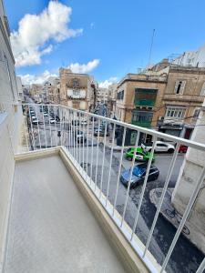 a balcony with a view of a parking lot at The Rue in Il-Gżira