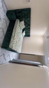 a mirror on a wall above a refrigerator at Premium House Kouritenga ISPP in Ouagadougou +1 photo