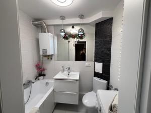 a bathroom with a sink and a toilet and a mirror at Ekskluzywny Apartament Joanna w centrum Bochni in Bochnia +13 photos