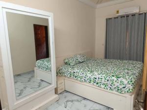 a bedroom with a mirror and a bed at Premium House Kouritenga ISPP in Ouagadougou