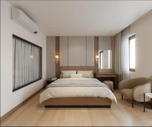 a bedroom with a large bed and a chair at Lam Anh Hotel 9 Him Lam Vạn Phúc in Hà Ðông +17 photos