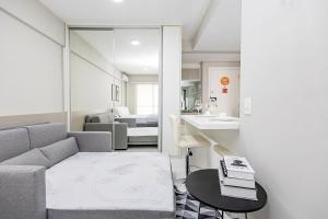 a living room with a couch and a table at Edifício Champagnat Office in Curitiba