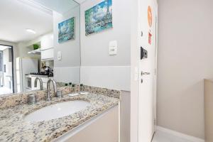 a bathroom with a sink and a mirror at Edifício Champagnat Office in Curitiba