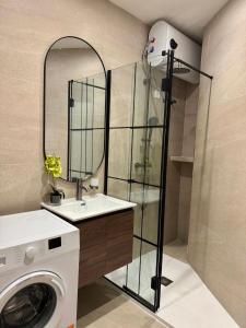 a bathroom with a sink and a washing machine at Modern Designer Stay near Sliema Seafront in Il-Gżira +50 photos