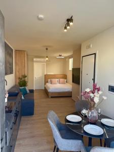 a living room with a bed and a table and chairs at The Rue in Il-Gżira +50 photos