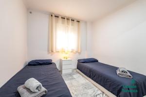 Ένα ή περισσότερα κρεβάτια σε δωμάτιο στο Apartamento moderno en el centro de Huelva